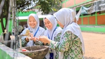 Three young children washing their hands