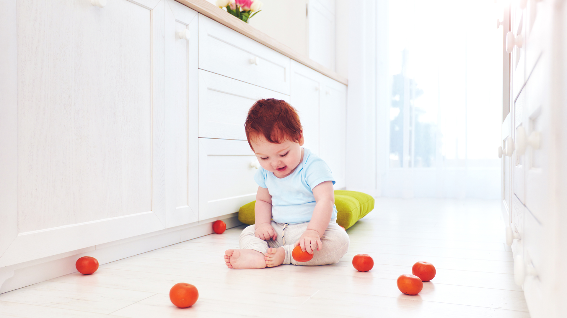Child playing on a clean kitchen floor