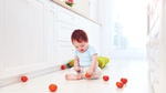 Child playing on a clean kitchen floor