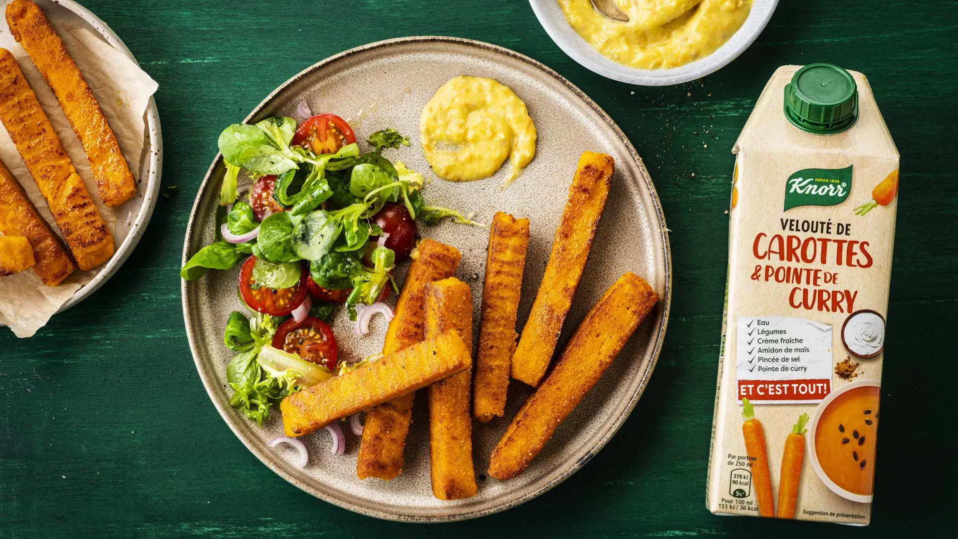 A container of Knorr 'Carrots and a hint of Curry' next to a plate of food