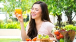 A woman drinking a fruit juice