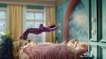Person floating in a colorful bedroom with pink bedding