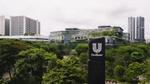 Modern building with Unilever sign surrounded by trees.
