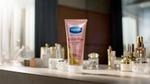 Vaseline Gluta-Hya Dewy Radiance lotion on a table with cosmetics.